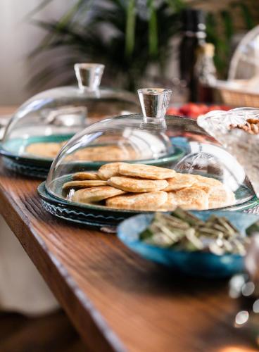 a table with plates of food on a table at Sella&Mosca Casa Villamarina in Alghero