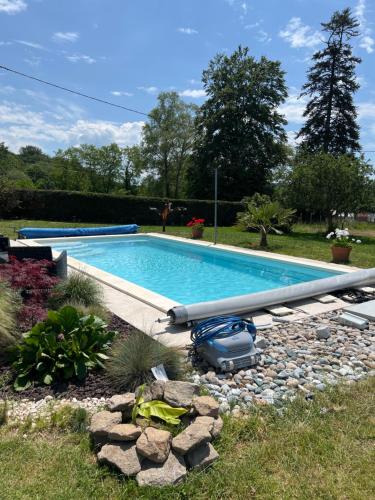 a large swimming pool in a yard with a landscaping at Studio au calme avec piscine partagée in Saint-Martin-la-Méanne