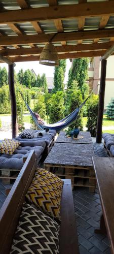 a group of hammocks under a wooden pergola at Трушки34 in Trushki