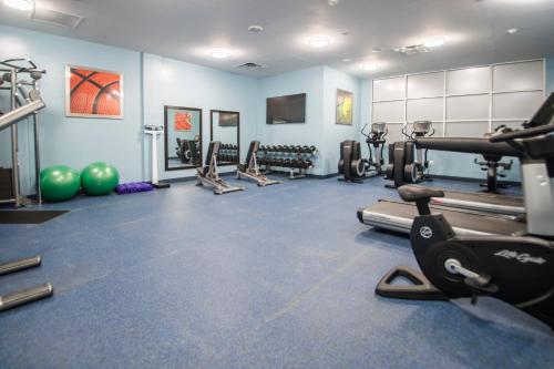 a gym with several treadmills and exercise equipment at Four Points by Sheraton Houston Intercontinental Airport in Houston