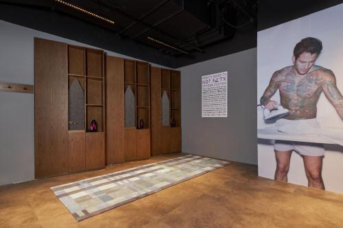 a room with a painting of a man on a wall at Moxy Shanghai Xuhui in Shanghai