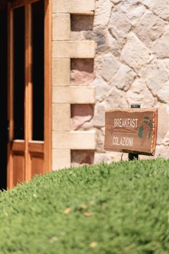 a sign on top of a hill in front of a building at Sella&Mosca Casa Villamarina in Alghero