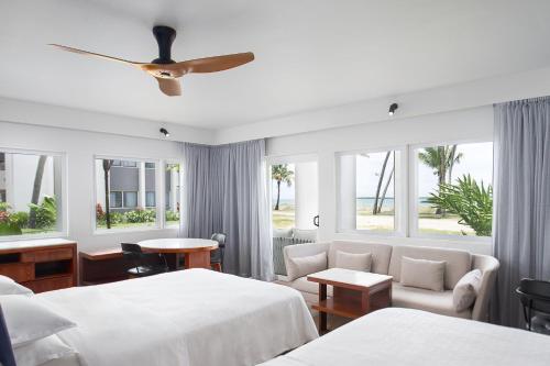 Sheraton Fiji Golf & Beach Resort في ديناراو: غرفة فندقية بسريرين ونافذة