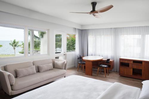 a living room with a couch and a table at Sheraton Fiji Golf & Beach Resort in Denarau