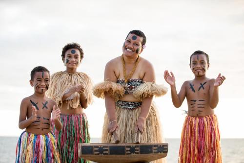 a group of women in traditional costumes on the beach at Sheraton Fiji Golf & Beach Resort in Denarau