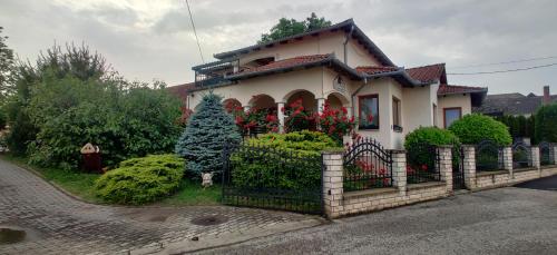 a house with a fence in front of it at Aurora Ház in Zalakaros