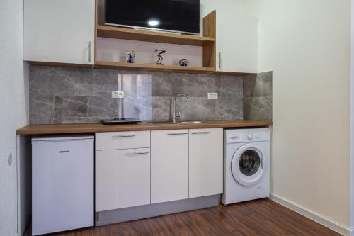 a kitchen with a sink and a washing machine at Apartment Lavanda Neum in Neum