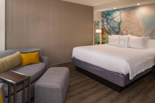 a hotel room with a bed and a couch at Courtyard by Marriott Temecula Murrieta in Murrieta