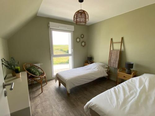 Ένα ή περισσότερα κρεβάτια σε δωμάτιο στο Wimereux proche plage et centre