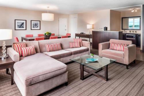 a living room with a couch and chairs and a table at Delta Hotels by Marriott Sault Ste. Marie Waterfront in Sault Ste. Marie