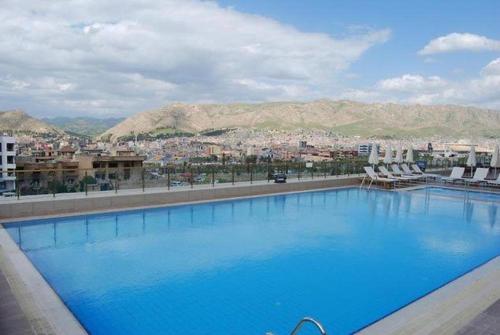 a large swimming pool with a view of a city at Crixus Duhok in Duhok