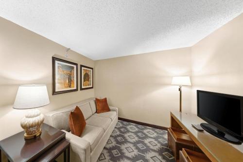 a living room with a couch and a tv at The Westin San Antonio North in San Antonio