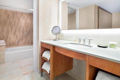 a bathroom with a sink and a mirror at The Westin Edmonton in Edmonton