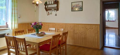 a dining room with a wooden table and chairs at Chalupa na Koskách in Třeboň