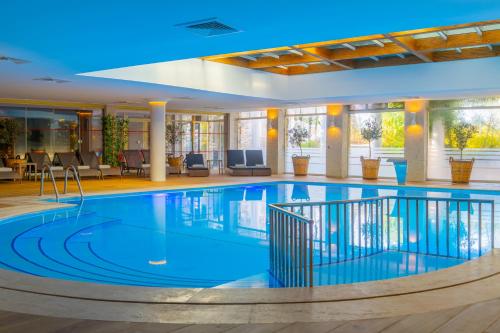 a large swimming pool in a hotel lobby at Mark Warner Phokaia Beach Resort in Foca