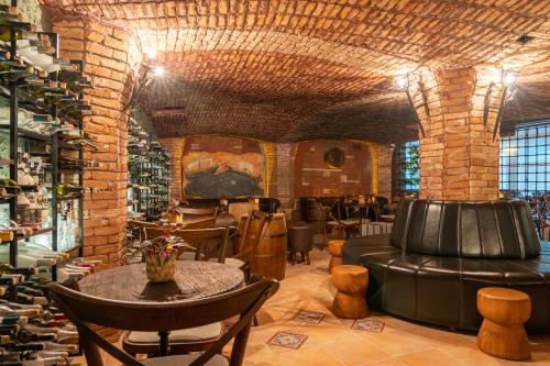a bar with leather chairs and tables in a room at Mark Warner Phokaia Beach Resort in Foca