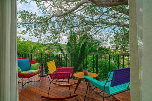 a group of chairs and tables on a deck at W Punta de Mita in Punta Mita