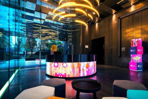 a lobby with a tub in the middle of a building at Aloft Taipei Zhongshan in Taipei