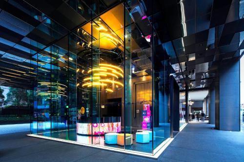 a glass facade of a building with a store window at Aloft Taipei Zhongshan in Taipei