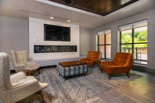 a living room with chairs and a fireplace at Four Points by Sheraton Deadwood in Deadwood