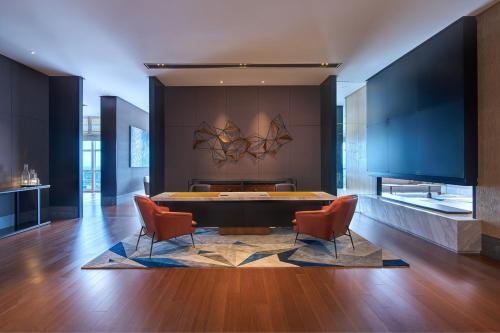a living room with a table and two chairs at Le Meridien Petaling Jaya in Petaling Jaya