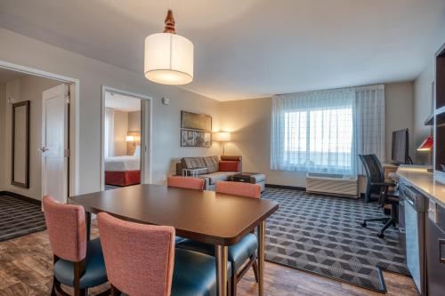 a living room with a table and chairs at TownePlace Suites by Marriott Indianapolis Airport in Indianapolis
