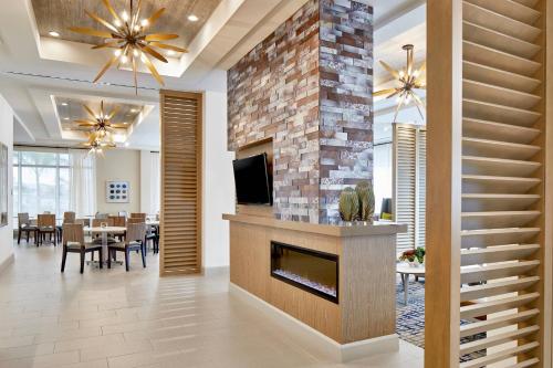 a living room with a fireplace and a dining room at Residence Inn St. Petersburg Tierra Verde in Tierra Verde