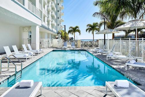 a swimming pool with lounge chairs and a hotel at Residence Inn St. Petersburg Tierra Verde in Tierra Verde