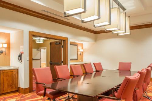 a conference room with a table and red chairs at Louisville Marriott East in Louisville