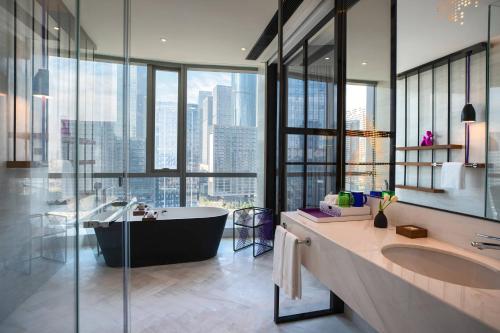 a bathroom with a tub and a large window at Renaissance Nanning Hotel in Nanning