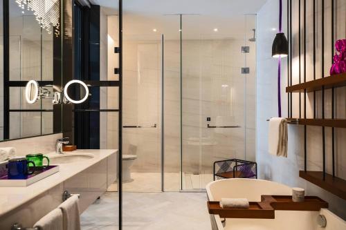 a bathroom with a shower and a sink and a toilet at Renaissance Nanning Hotel in Nanning