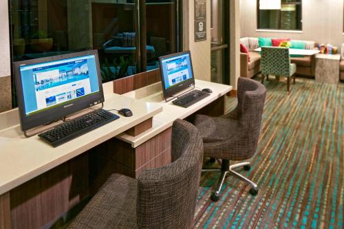a room with two computers on a desk with chairs at Residence Inn by Marriott Los Angeles Redondo Beach in Redondo Beach