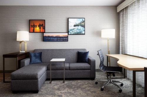 a living room with a couch and a desk at Residence Inn by Marriott Los Angeles Redondo Beach in Redondo Beach