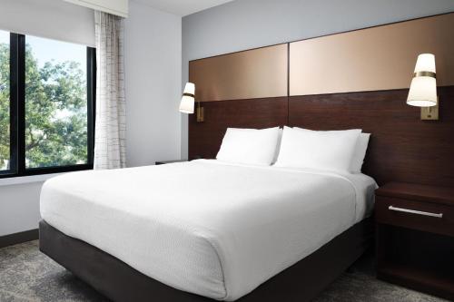 a bedroom with a large bed and a large window at Residence Inn by Marriott Los Angeles Redondo Beach in Redondo Beach