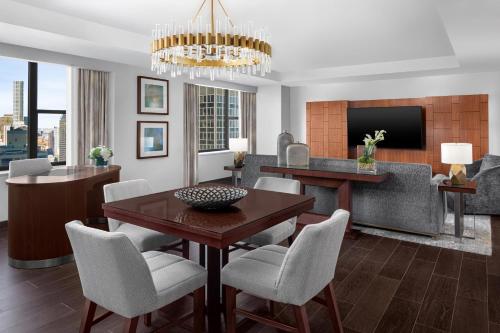 a living room with a table and chairs at The Westin New York Grand Central in New York