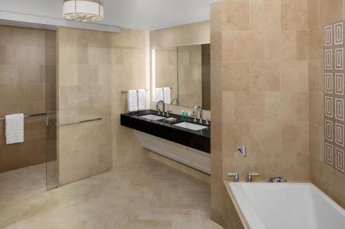 a bathroom with a sink and a bath tub at The Westin New York Grand Central in New York