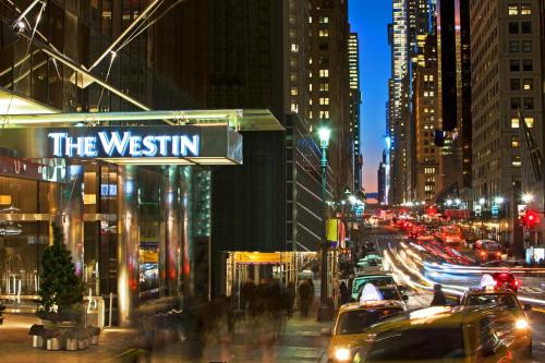 a city street at night with a sign for the westin at The Westin New York Grand Central in New York
