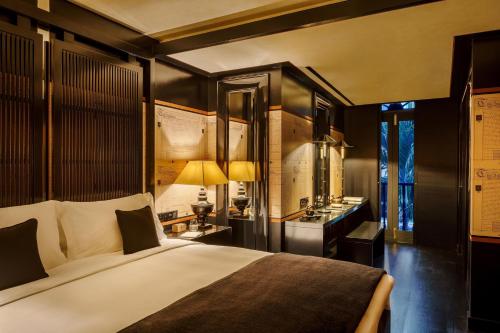 a bedroom with a large bed and a desk at Duxton Reserve Singapore, Autograph Collection in Singapore
