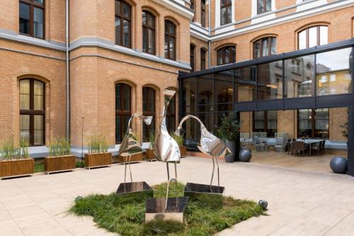 two metal sculptures in front of a building at AC Hotel by Marriott Wroclaw in Wrocław