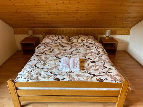 a bed with two slippers on it in a room at Apartman MAURO in Rakovica