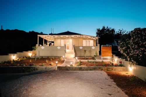 a house with lights in front of it at night at Elais House Methoni in Methoni