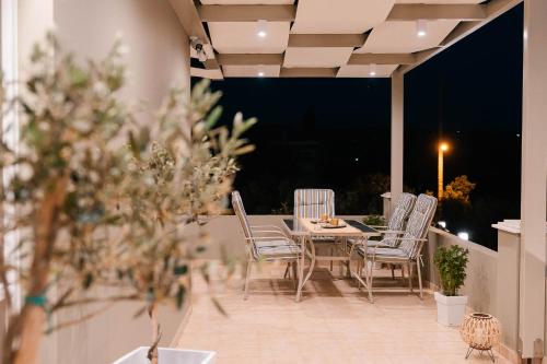 a table and chairs on a patio at night at Elais House Methoni in Methoni