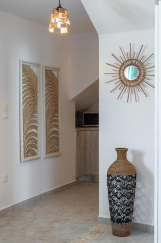 a room with a vase and a mirror on the wall at Kapetan Giannis Suite in Adamas