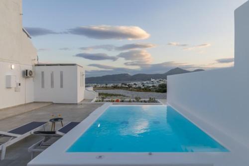 a swimming pool on the roof of a house at Kapetan Giannis Suite in Adamas