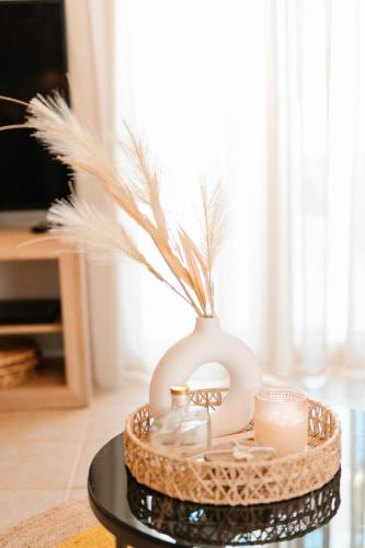 a tray with a vase and candles on a table at Elais House Methoni in Methoni