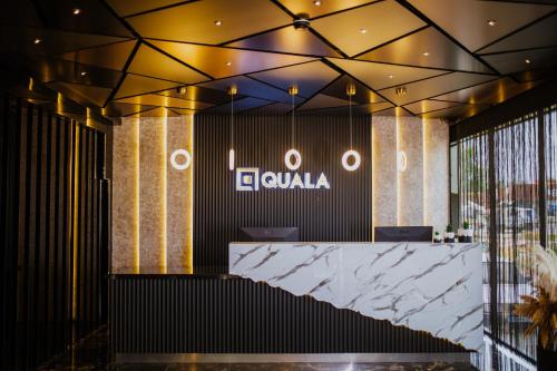 a lobby with a reception desk and a sign at QUALA HOTELS & LOUNGE in Aksaray