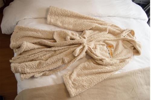 a blanket laying on top of a bed at Relax Inn Sandton Designed For Relaxation in Johannesburg