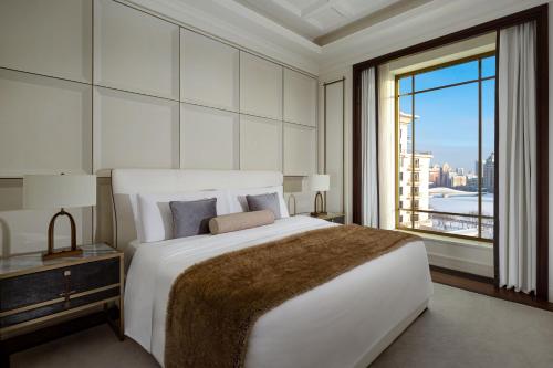 a white bedroom with a large bed and a window at The St. Regis Astana in Astana