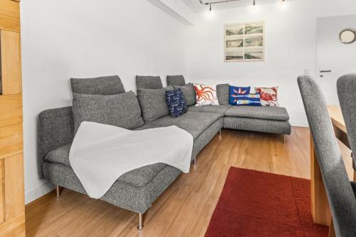 a living room with a couch with a blanket on it at Juister Unterdeck 3ZKB in Juist