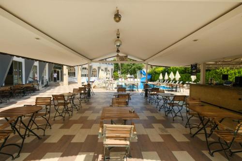 an empty patio with tables and chairs in a building at Club Selen icmeler in Marmaris